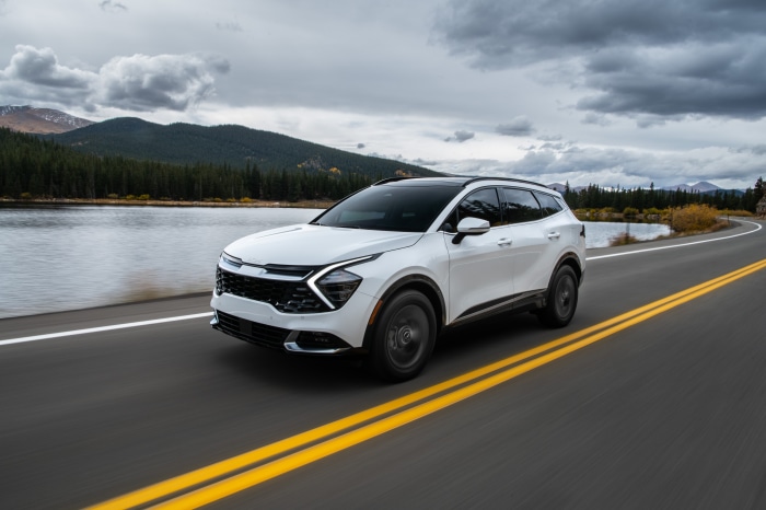 White Kia Sportage SX 4K driving on a road