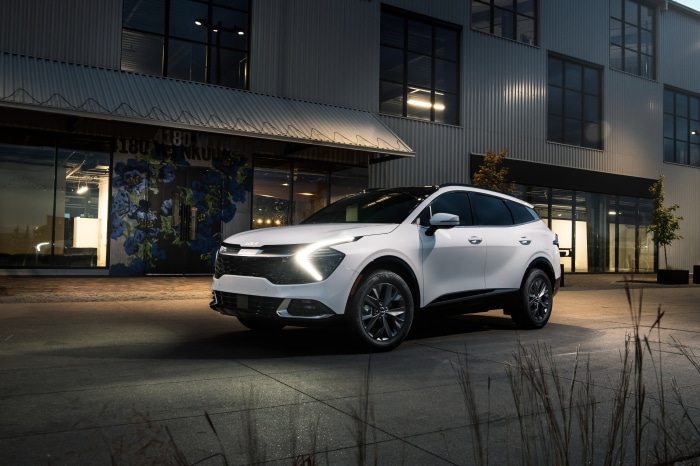 White Kia Sportage SX 4K SUV parked outside building