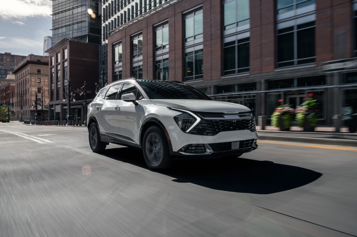 White Kia Sportage SX 4K driving in city