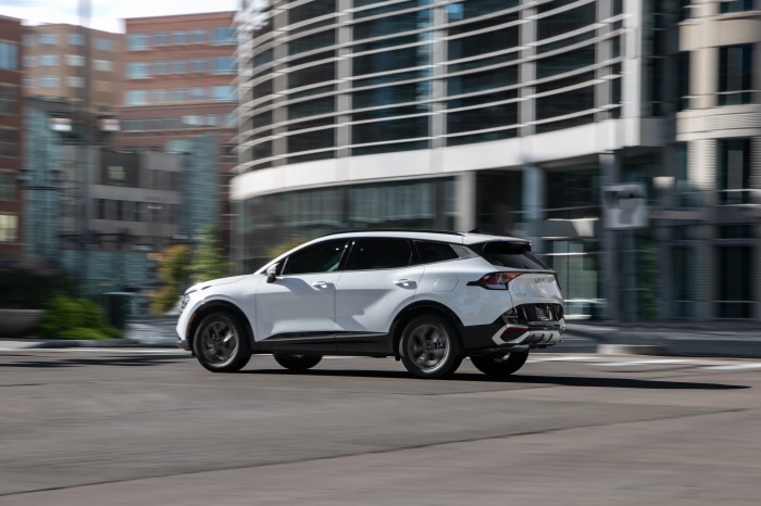 White Kia Sportage SX 4K driving in city