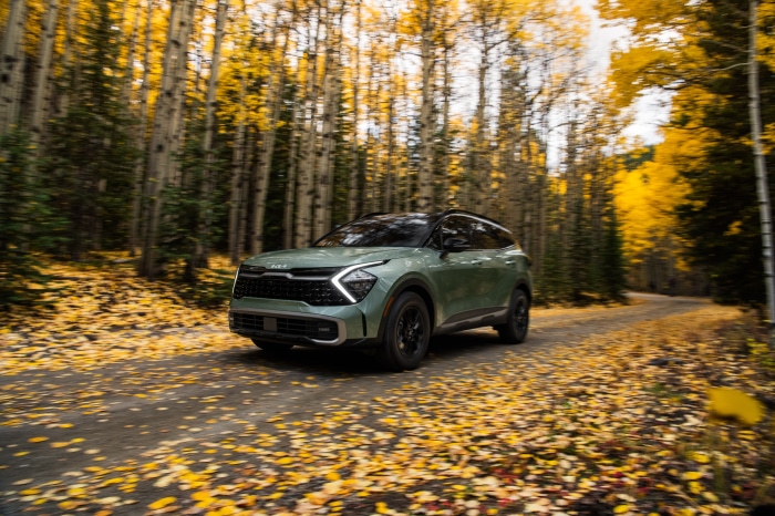 Kia Sportage X-Pro 4K SUV driving on a forest road