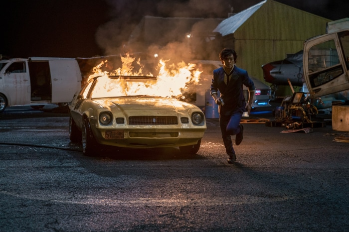 Spike Spiegel from Cowboy Bebop running from burning car
