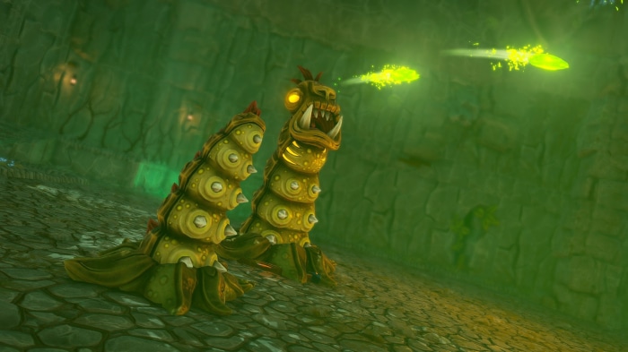 Two worm-like creatures shooting projectiles in a cave