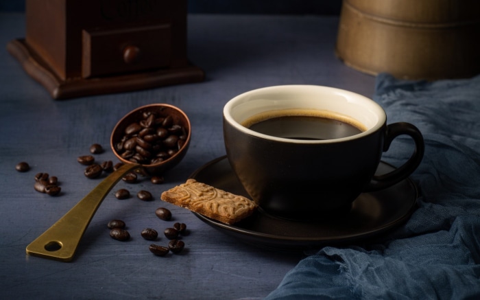 Coffee cup with beans and cookie