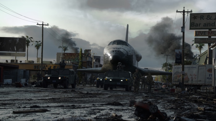 Space Shuttle in a destroyed city with military vehicles