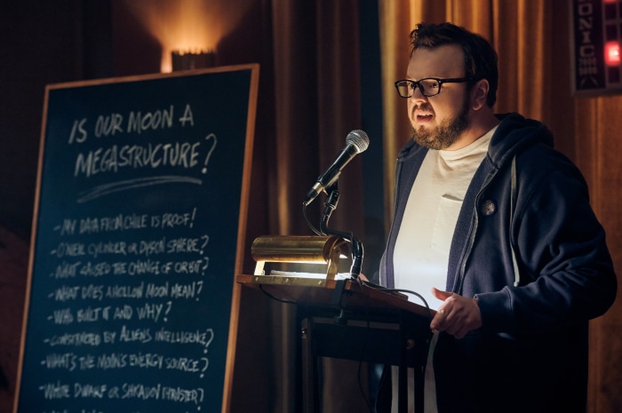 John Bradley presenting at a podium