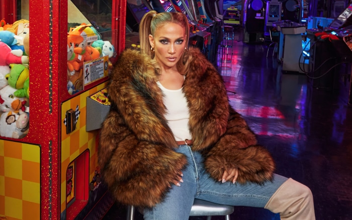 Jennifer Lopez in a fur coat in an arcade