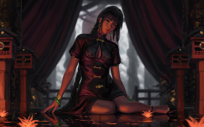 Woman in a black dress sitting on a reflective surface