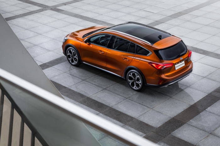 Orange Ford Focus Shooting Brake parked on tiled ground
