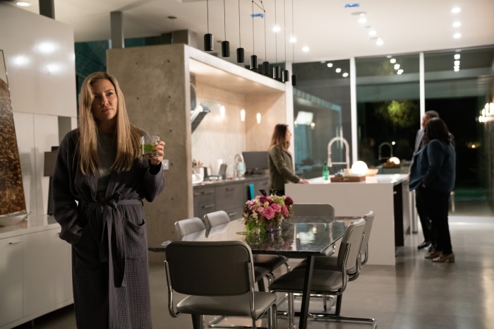 Kate Hudson in a robe holding a drink