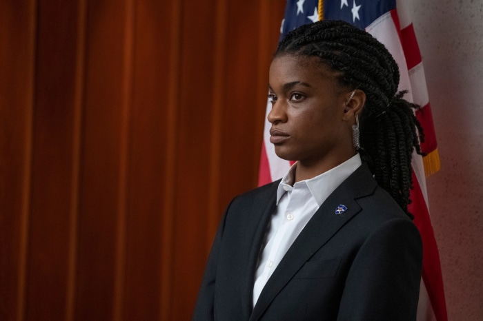 Woman in suit with US flag