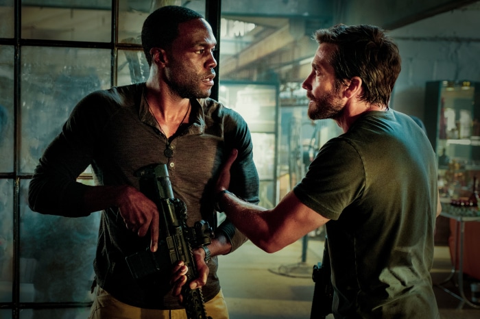 Jake Gyllenhaal and Yahya Abdul-Mateen II with a rifle