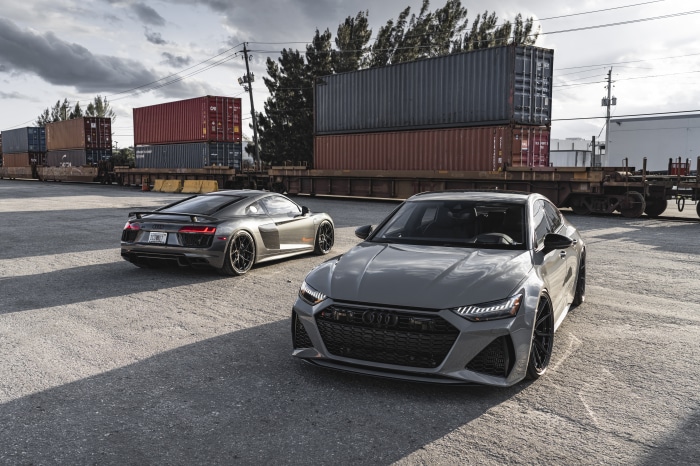 Audi R8 and Audi RS7 parked near shipping containers
