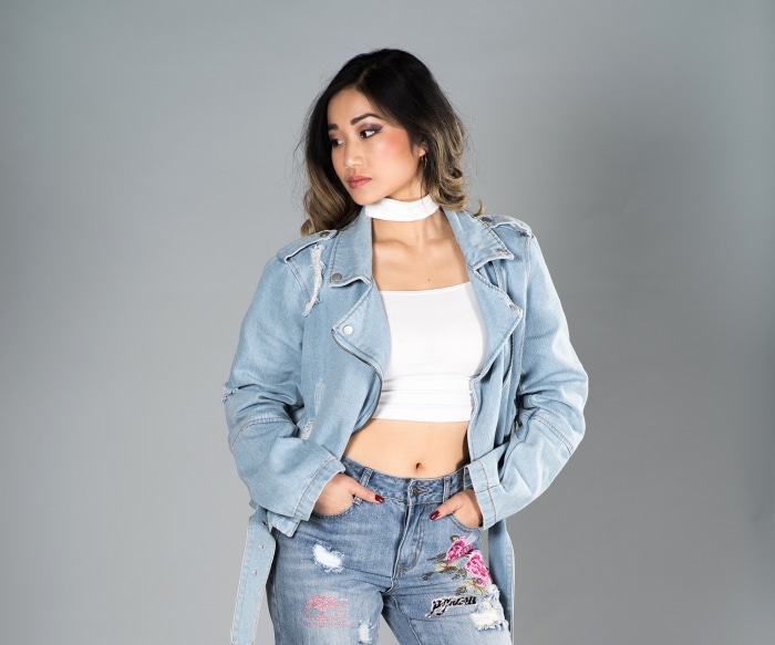 Asian woman in denim jacket and jeans