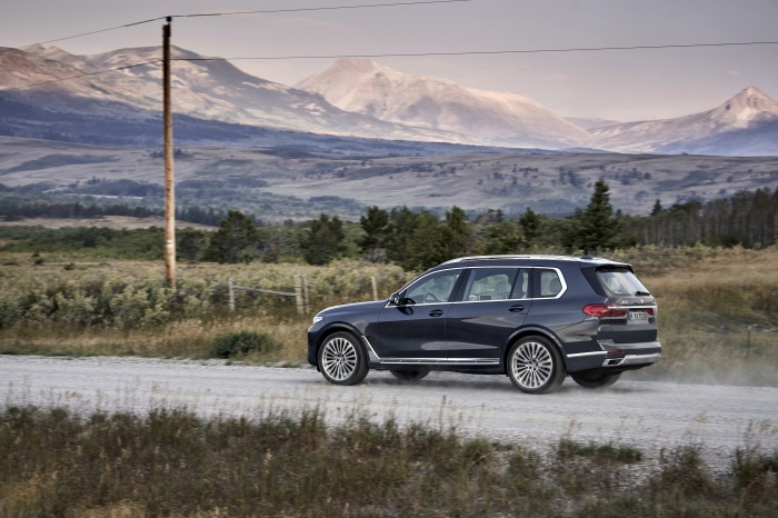 BMW X7 4K SUV driving on a dirt road