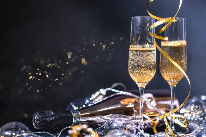 Champagne glasses and bottle with festive decorations