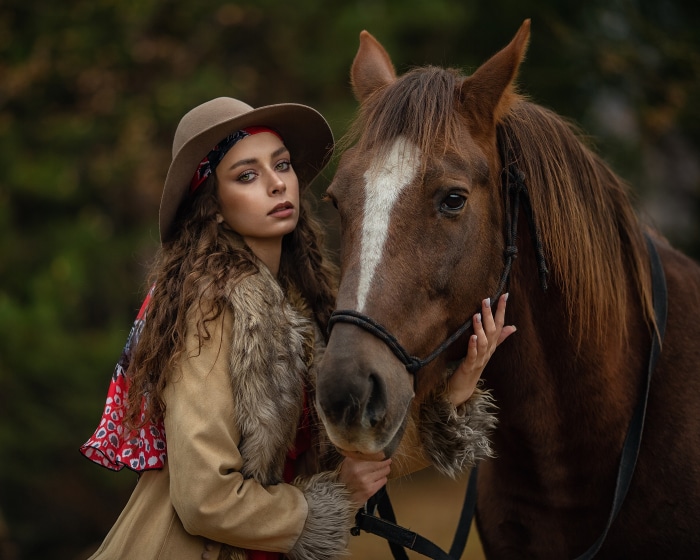 Woman in hat with horse