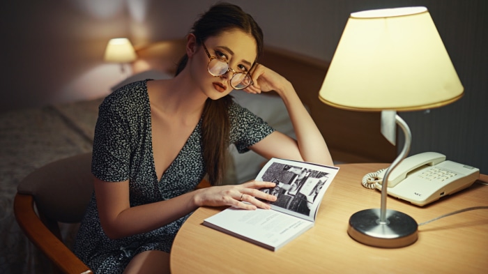 Woman wearing glasses reading a book