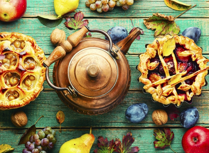Still life with pies, fruit, and copper teapot