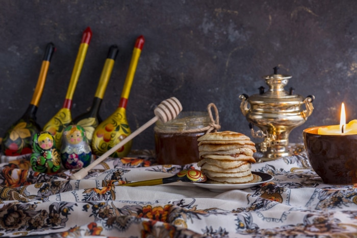 Still life with pancakes, honey, and Russian nesting dolls