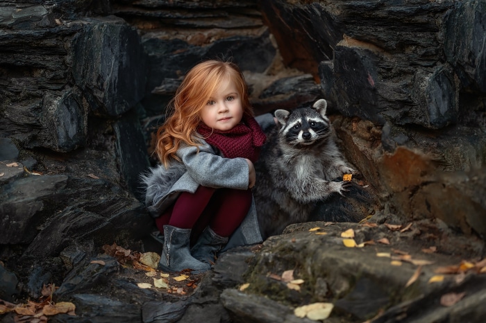 Girl and Raccoon in Rocky Den