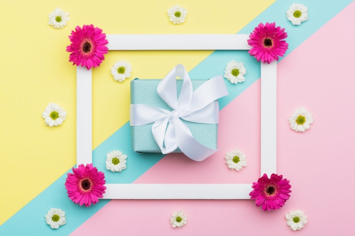Gift box with flowers on a colorful background