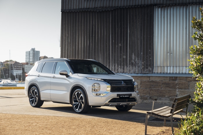 Mitsubishi Outlander SUV parked by a building
