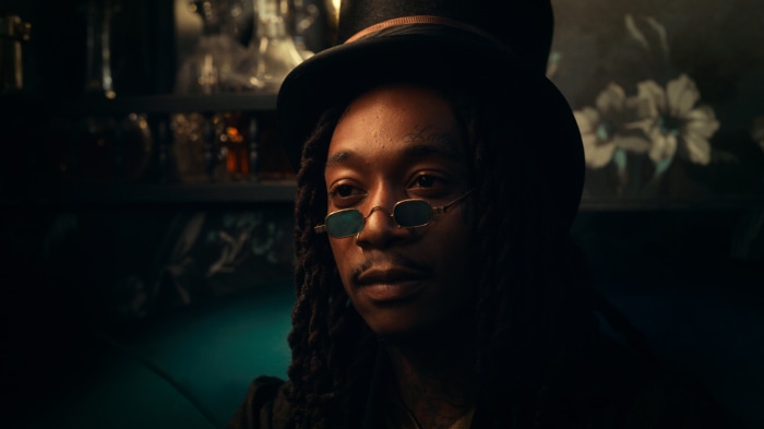 Wiz Khalifa wearing a top hat and glasses