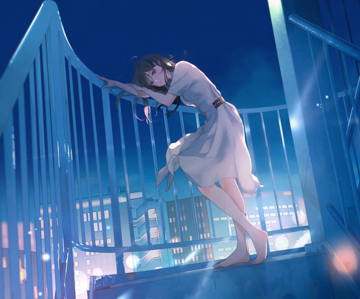 Girl in a white dress on a balcony at night