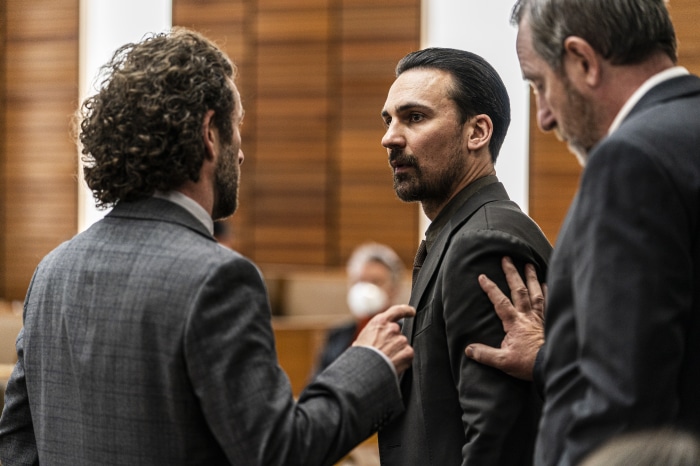 Henry Lloyd-Hughes in a courtroom