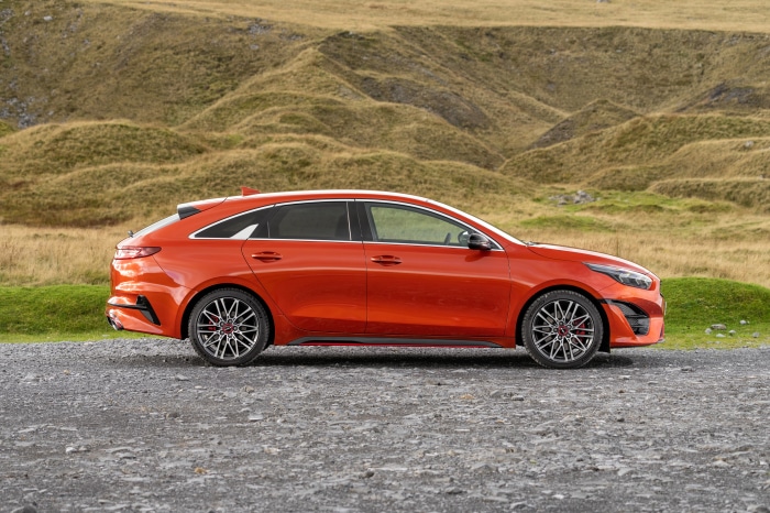 Orange Kia ProCeed GT parked on gravel road