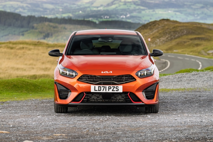 Orange Kia Ceed GT parked on gravel road