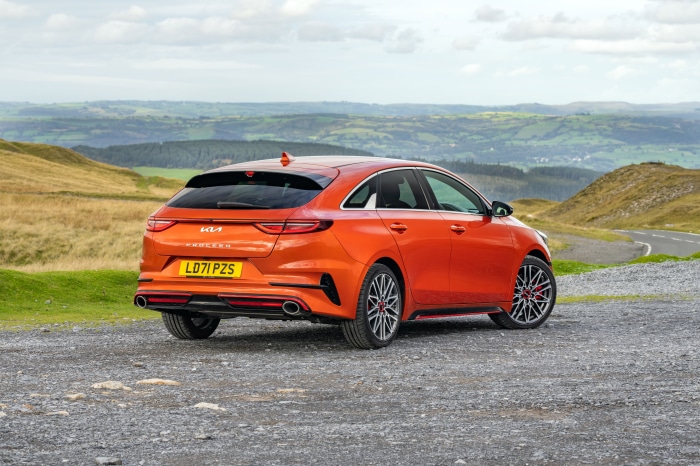 Orange Kia ProCeed GT parked on gravel road