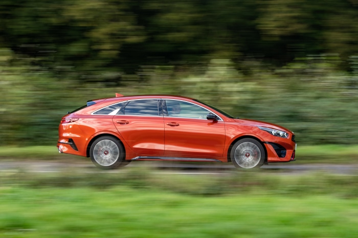Orange Kia ProCeed GT driving on a road