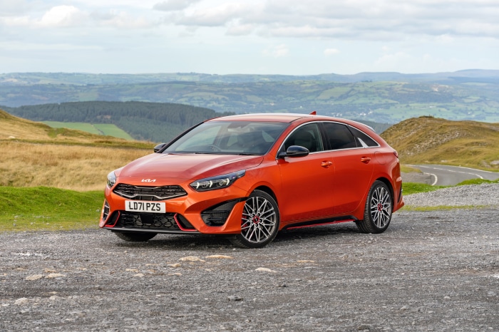 Orange Kia ProCeed GT parked on gravel road