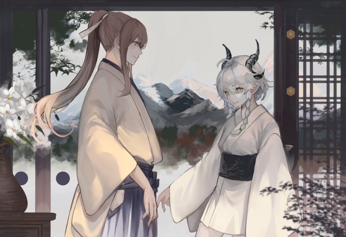 Two people in kimonos with mountains in the background
