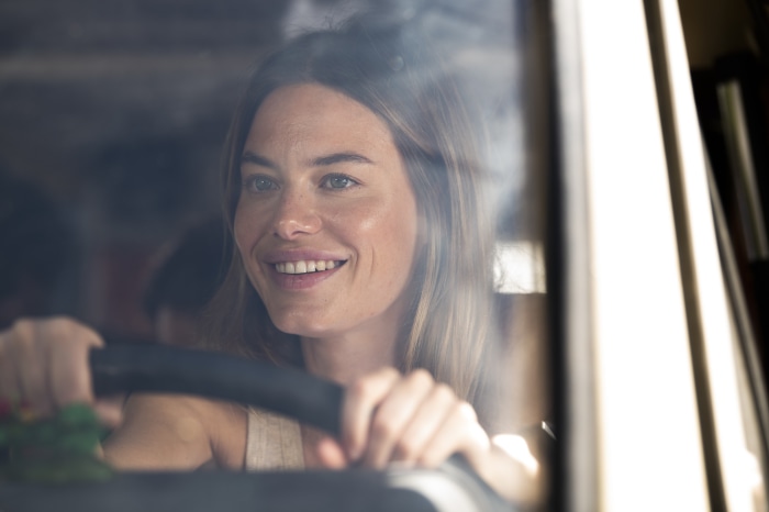 Camille Rowe driving a car