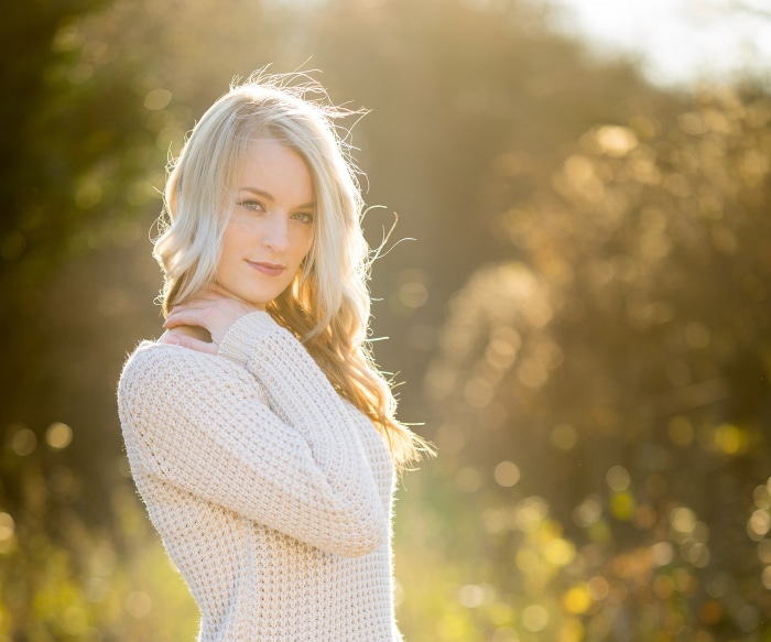 Woman with blonde hair wearing a sweater