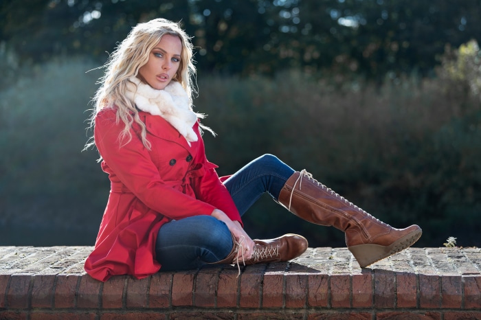 Woman in red coat and brown boots