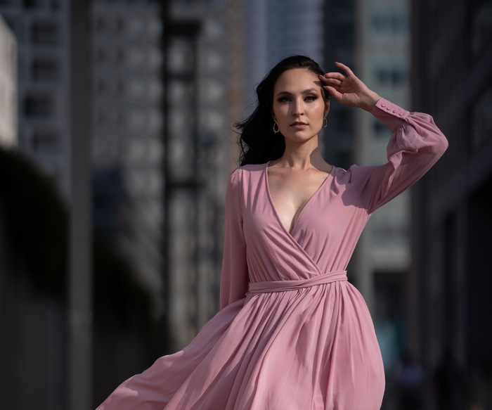 Woman in a pink dress in a city