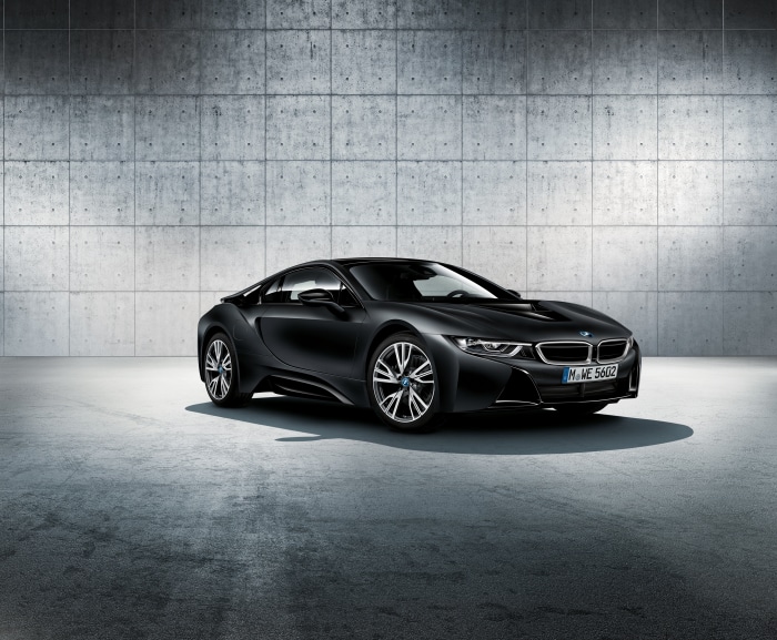 Black BMW i8 parked in front of concrete wall