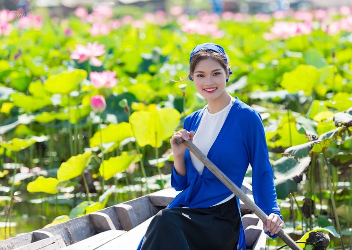 Woman in a boat in a lotus field