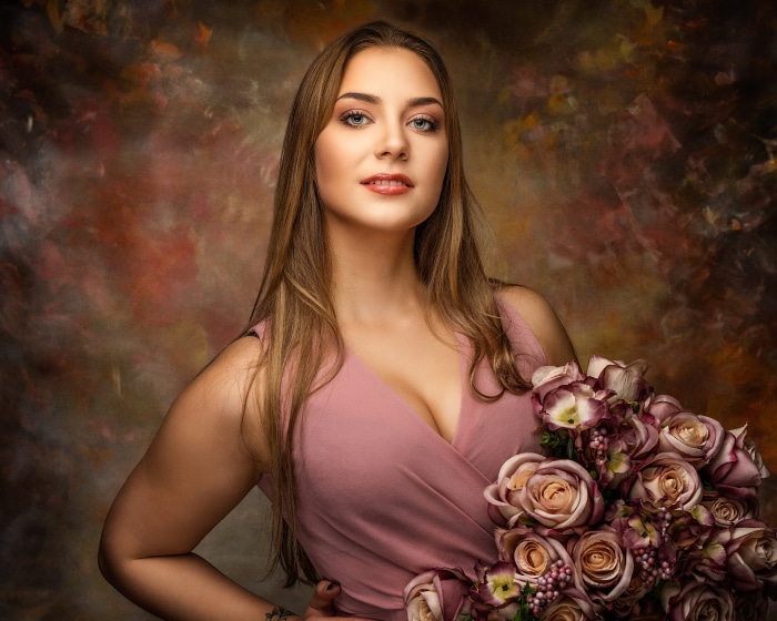 Brunette Model in Pink Dress Holding Roses
