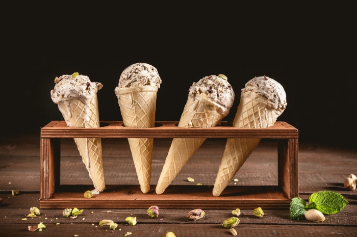 Four ice cream cones in a wooden holder