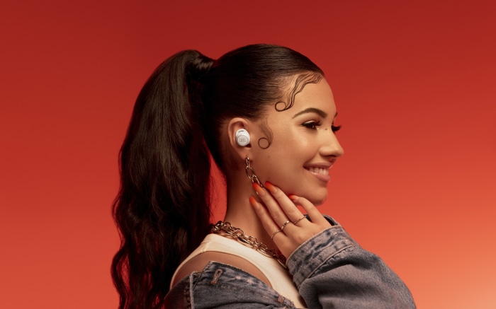 Woman with ponytail wearing earbuds