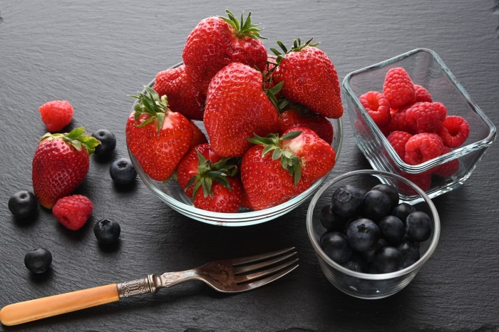 Strawberries, Raspberries, and Blueberries with a Fork