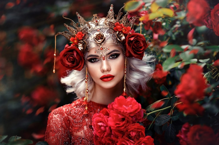 Woman in ornate headdress with red roses