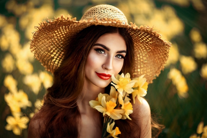 Woman in a straw hat with daffodils