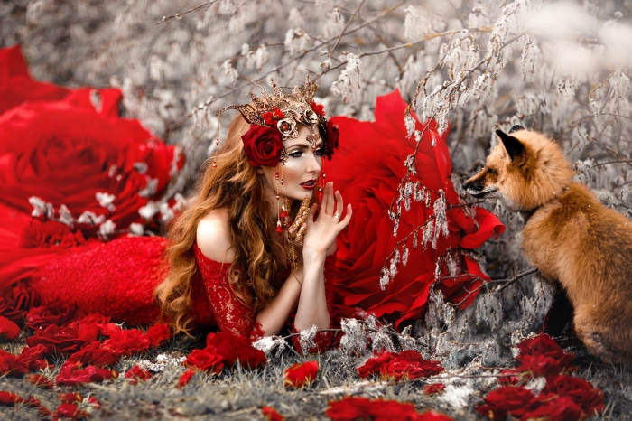 Woman in red dress with fox and roses