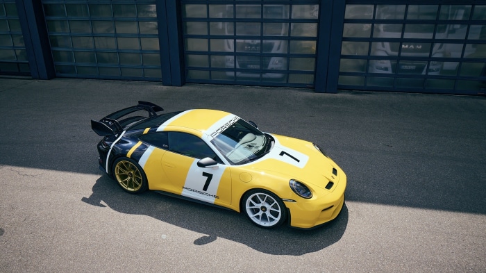 Yellow and black Porsche 911 GT3 with racing livery